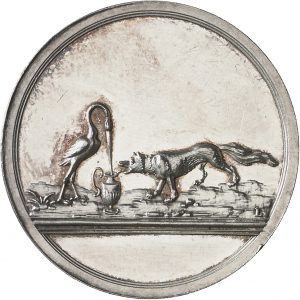 Münzevorderseite zeigt einen Storch, der links vor einem Krug steht, rechts daneben ein Fuchs. Rechts über Abschnitt die Signatur L der Medaillenfirma